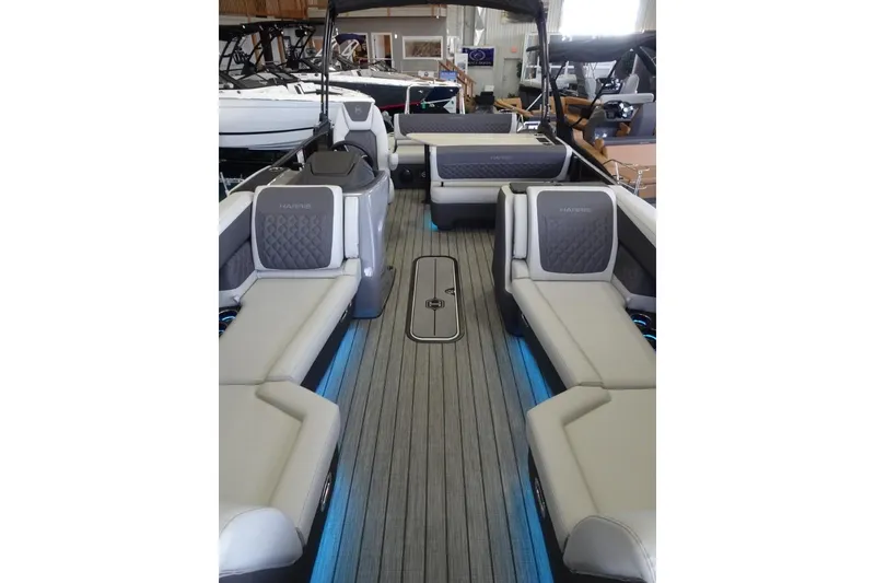 Slide: The Image of 2026 Harris Sunliner 250 boat interior with luxurious seating and modern design. - 12