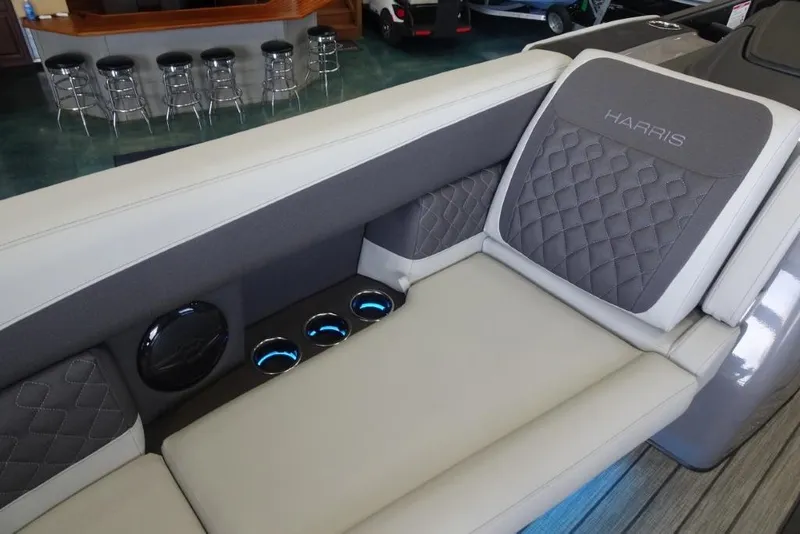 Slide: The Image of 2026 Harris Sunliner 250 boat interior with quilted seating and illuminated cup holders. - 13