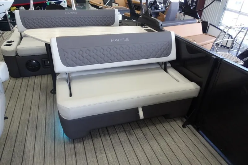 Slide: The Image of 2026 Harris Sunliner 250 boat interior with gray cushioned seating and modern design. - 16