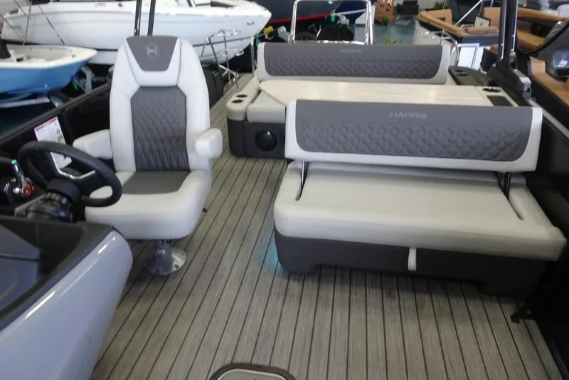 Slide: The Image of 2026 Harris Sunliner 250 boat interior with plush seating and modern design. - 17