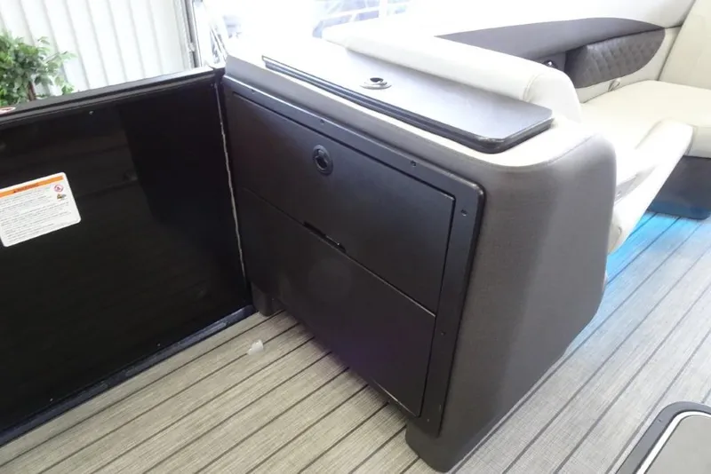 Slide: The Image of Interior of 2026 Harris Sunliner 250 boat, featuring sleek seating and storage compartments. - 18