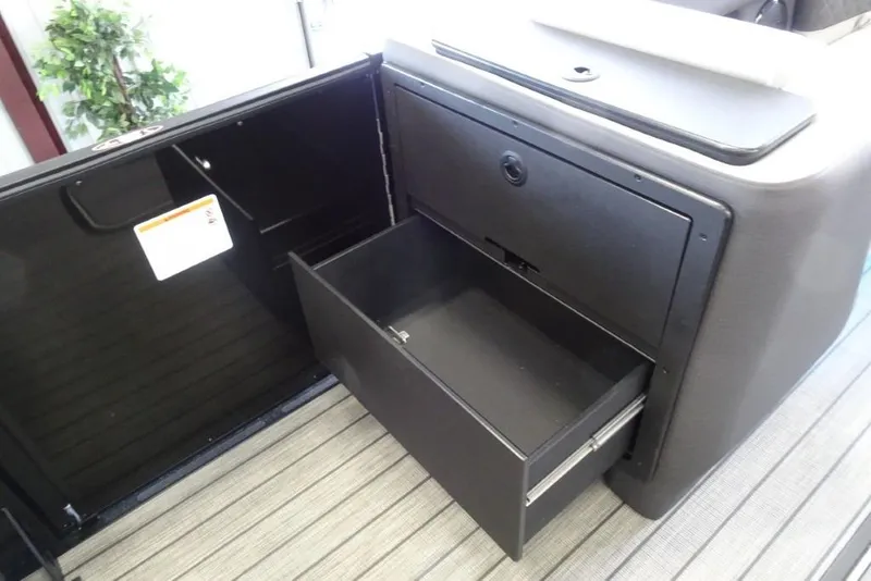 Slide: The Image of 2026 Harris Sunliner 250 storage compartment with open drawer, showcasing sleek design and functionality. - 20