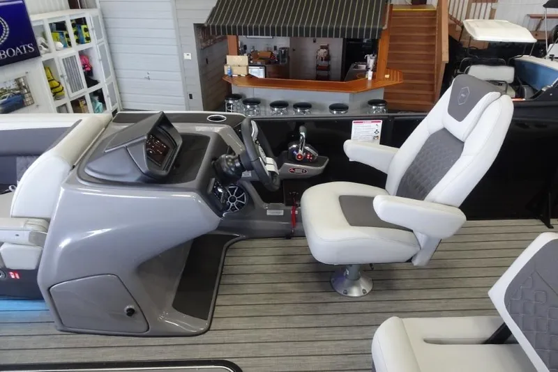 Slide: The Image of 2026 Harris Sunliner 250 boat interior with modern helm and comfortable captain's chair. - 21
