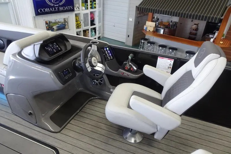 Slide: The Image of 2026 Harris Sunliner 250 helm with modern controls and comfortable captain's chair. - 22