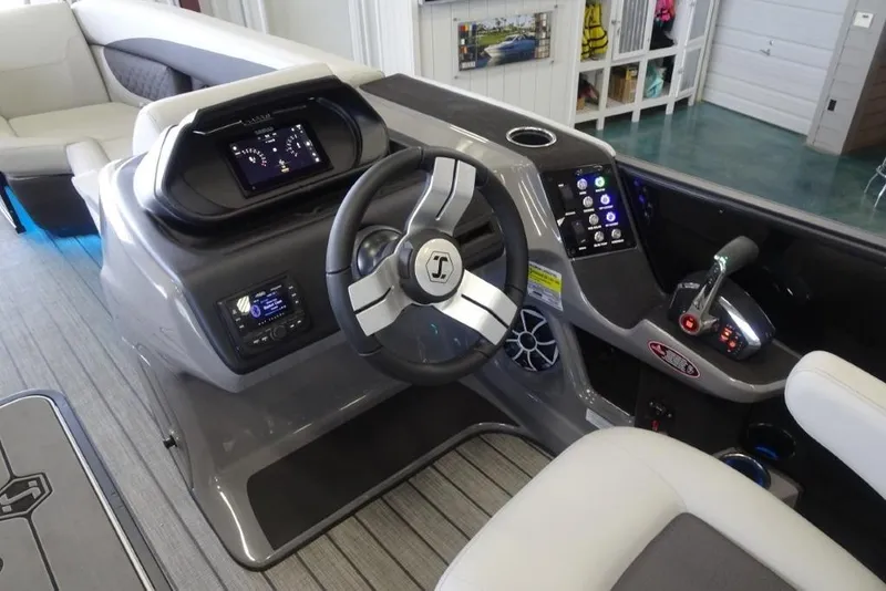 Slide: The Image of 2026 Harris Sunliner 250 boat dashboard with modern controls and steering wheel. - 23