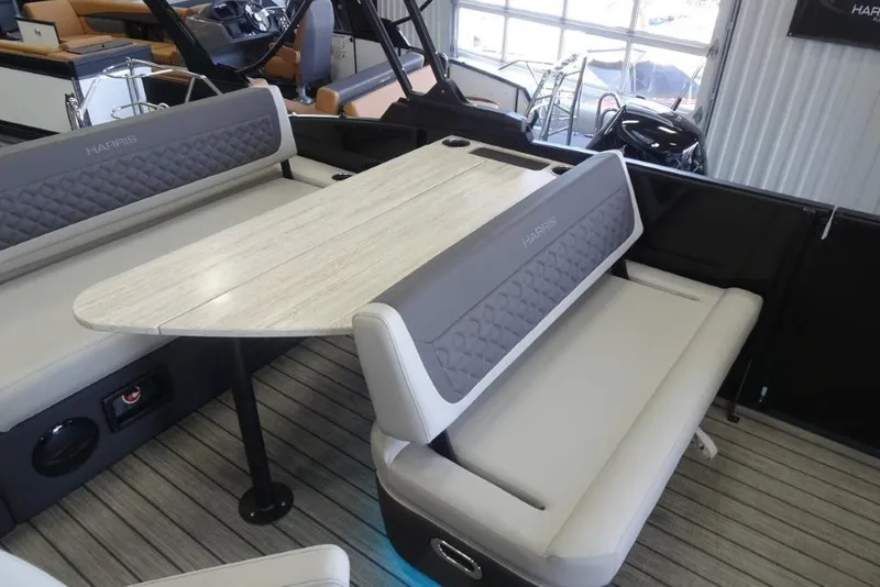 Slide: The Image of 2026 Harris Sunliner 250 interior with stylish seating and table, showcasing modern design. - 26