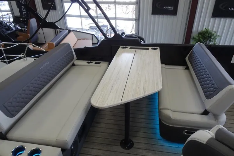 Slide: The Image of 2026 Harris Sunliner 250 interior with cushioned seating and a central table. - 27
