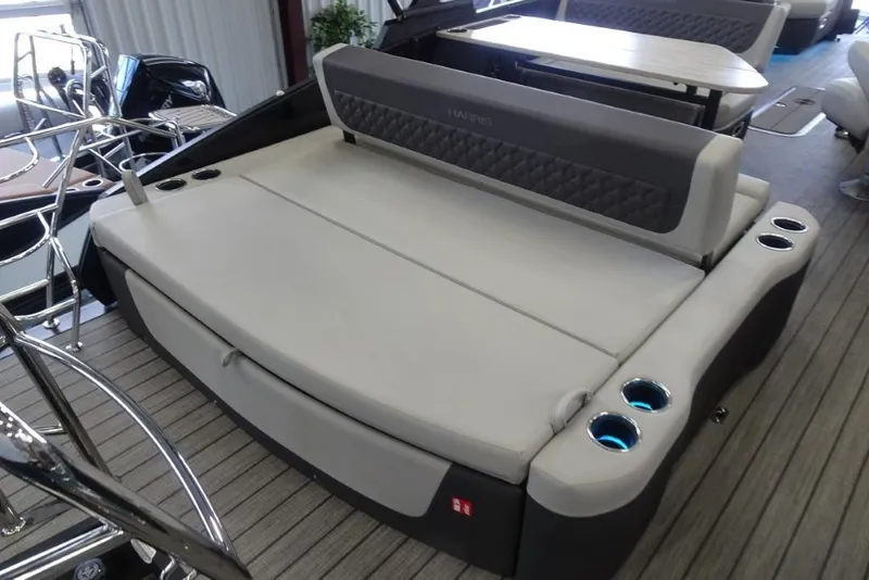 Slide: The Image of 2026 Harris Sunliner 250 boat interior with cushioned seating and cup holders. - 31
