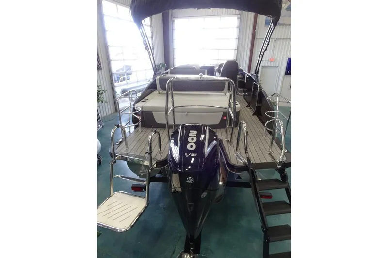 Slide: The Image of 2026 Harris Sunliner 250 pontoon boat with 200 V6 engine, showcased indoors. - 6