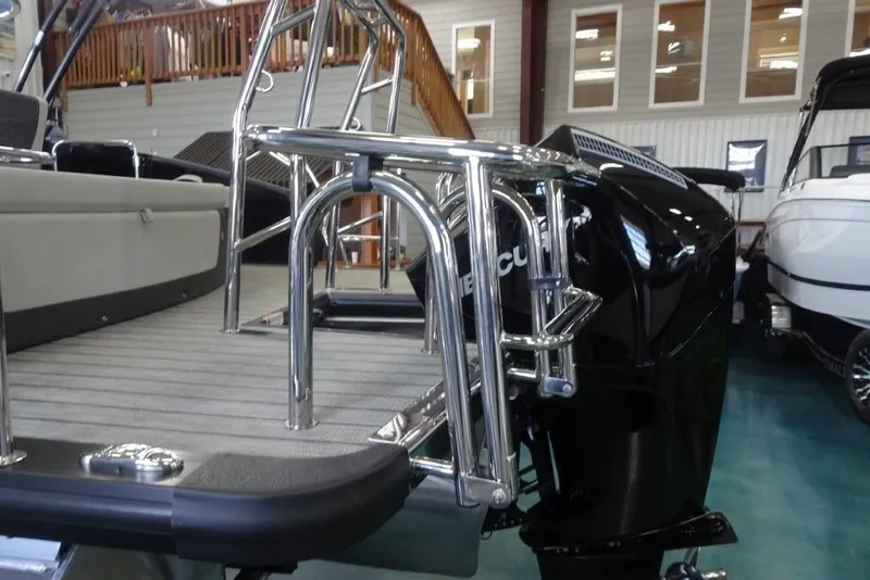 Slide: The Image of 2026 Harris Sunliner 250 boat with sleek design and powerful engine in showroom. - 7