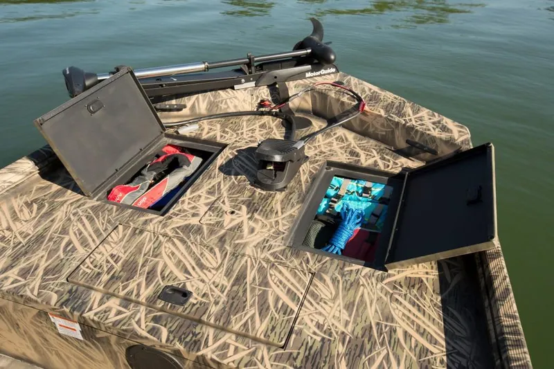 Slide: The Image of Manufacturer Provided Image: 2018 Lowe Roughneck 1760CC boat with open storage compartments on water. - 13