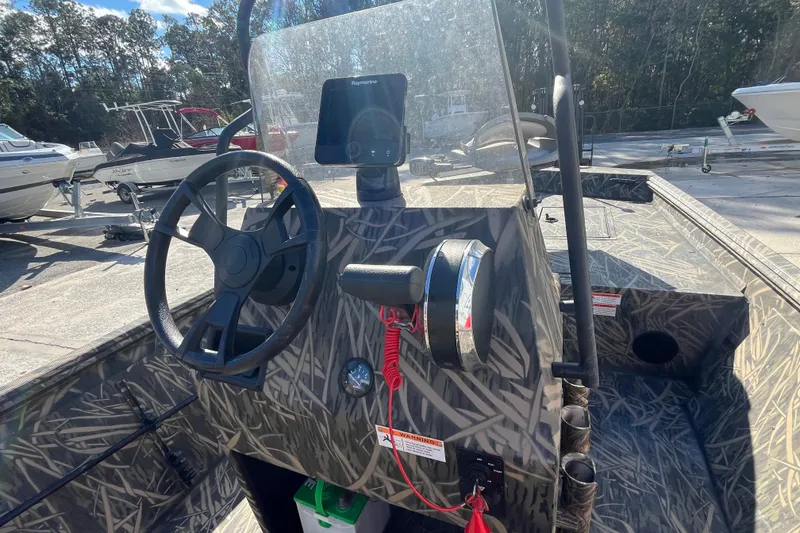 Slide: The Image of 2018 Lowe Roughneck 1760CC boat interior with steering wheel and control panel. - 15