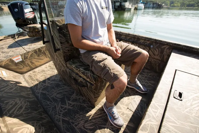 Slide: The Image of Manufacturer Provided Image: Man sitting on 2018 Lowe Roughneck 1760CC boat in camouflage design. - 18