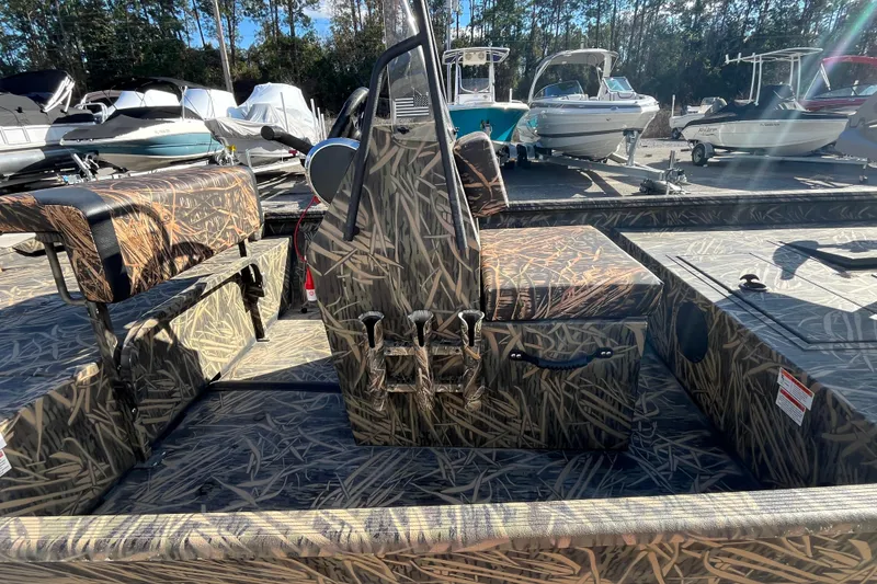 Slide: The Image of 2018 Lowe Roughneck 1760CC boat with camouflage design, surrounded by other boats. - 19