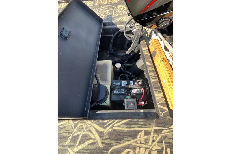 Slide: The Image of 2018 Lowe Roughneck 1760CC boat interior showing battery compartment and wiring. - 24