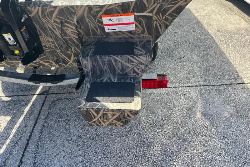 Slide: The Image of 2018 Lowe Roughneck 1760CC boat with camouflage pattern and trailer step detail. - 4