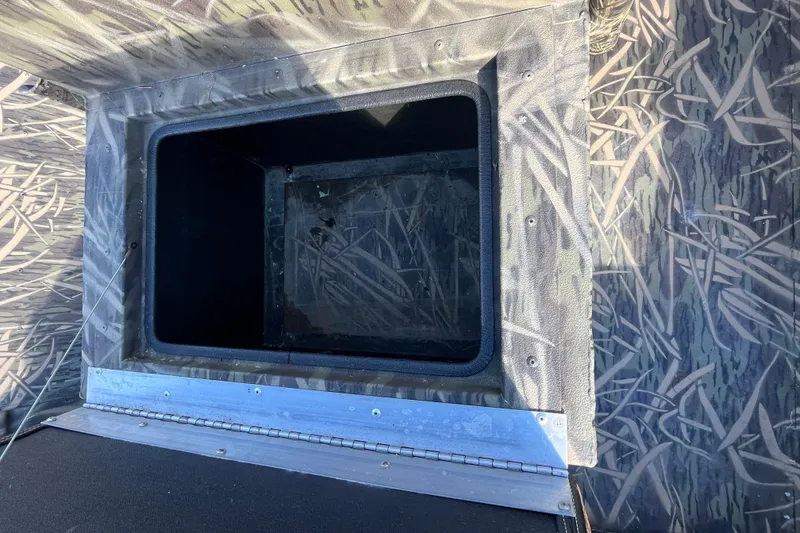 Slide: The Image of 2018 Lowe Roughneck 1760CC boat storage compartment with camouflage pattern. - 7