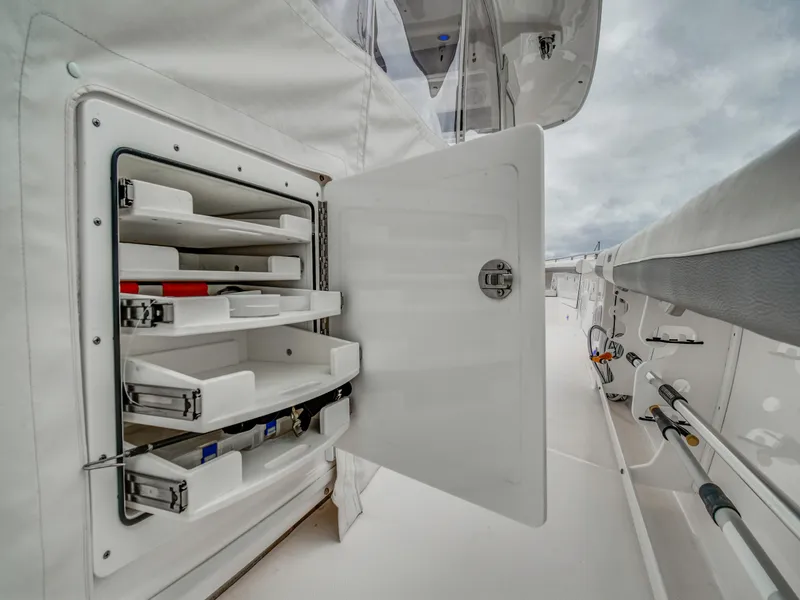 Slide: The Image of Open storage compartment on Everglades 435 Center Console boat, 2015 model. - 12
