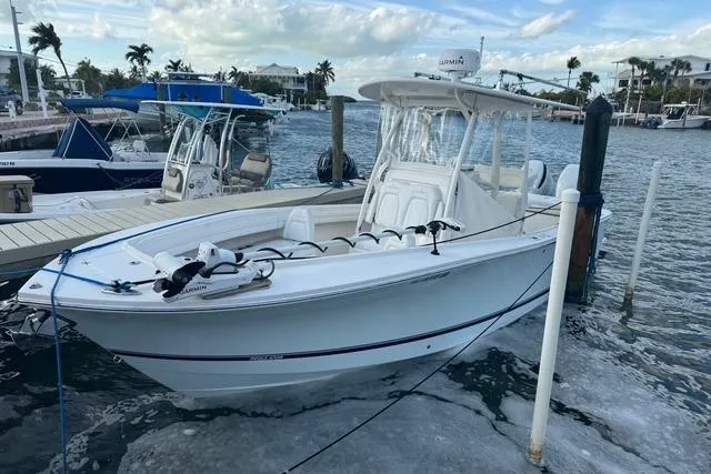 The Image of 2017 Regulator 25 boat docked in a marina with clear skies. - 0