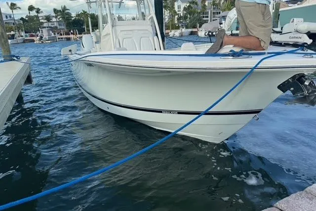 Slide: The Image of 2017 Regulator 25 boat docked in marina, calm waters, clear sky. - 1