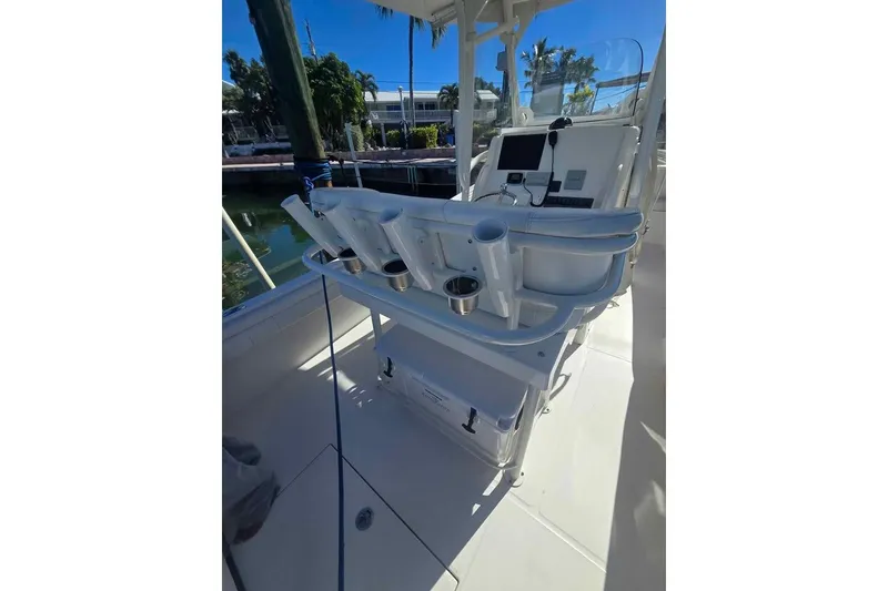 Slide: The Image of 2017 Regulator 25 boat interior with rod holders and control panel. - 12