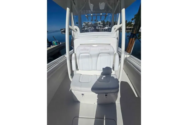Slide: The Image of 2017 Regulator 25 boat interior with white seating and clear skies. - 15