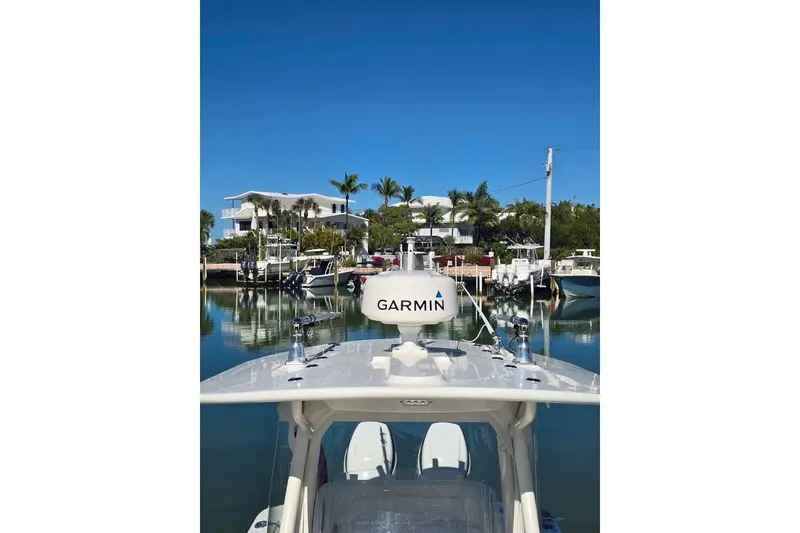 Slide: The Image of 2017 Regulator 25 boat with Garmin equipment docked in a scenic marina. - 16