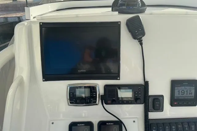 Slide: The Image of Control panel of a 2017 Regulator 25 boat with navigation and communication equipment. - 19