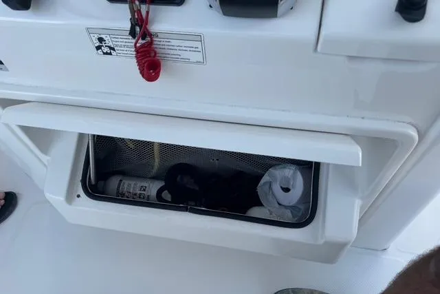 Slide: The Image of Storage compartment on a 2017 Regulator 25 boat with safety equipment. - 25