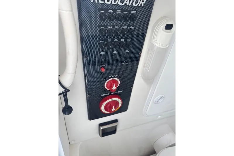 Slide: The Image of Control panel of a 2017 Regulator 25 boat with switches and dials. - 31