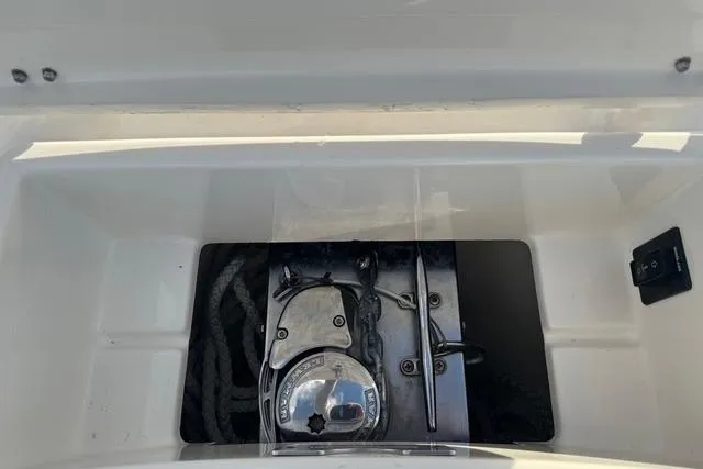 Slide: The Image of 2017 Regulator 25 boat anchor storage compartment with ropes and cleat. - 33