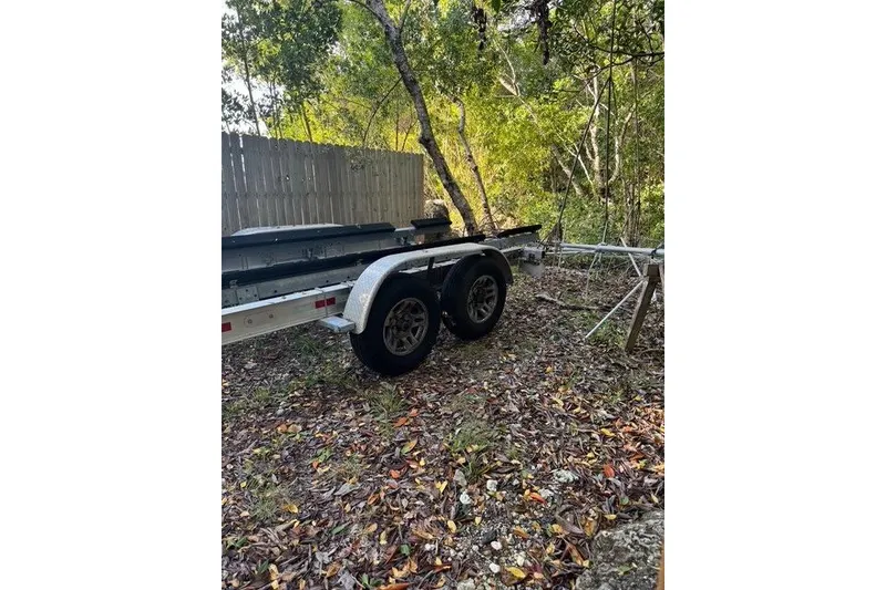 Slide: The Image of Trailer for 2017 Regulator 25 boat in wooded area. - 45