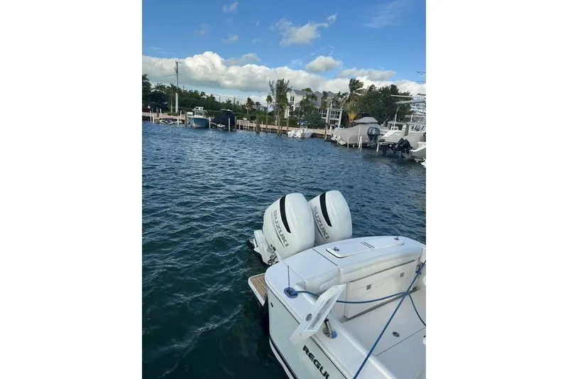 Slide: The Image of 2017 Regulator 25 boat with dual engines docked in a marina. - 6
