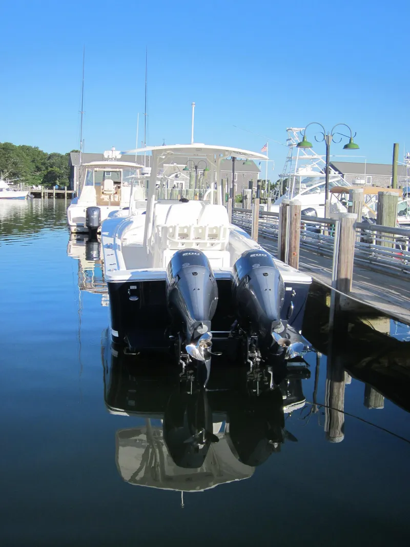 Slide: The Image of 2014 Regulator 25 boat docked with twin outboard engines. - 22