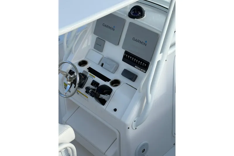 Slide: The Image of 2014 Regulator 25 boat console with Garmin navigation and steering wheel. - 25