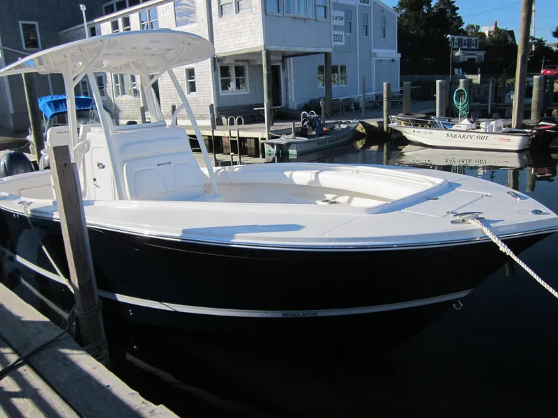 Slide: The Image of 2014 Regulator 25 boat docked on a sunny day. - 5