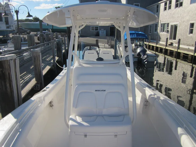 Slide: The Image of 2014 Regulator 25 boat docked on a sunny day. - 6