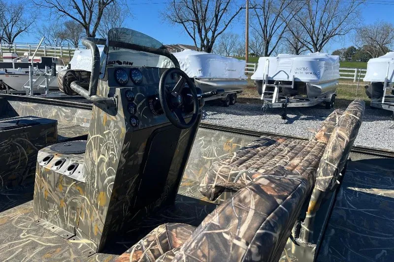 Slide: The Image of 2026 War Eagle 2170 Blackhawk boat with camouflage interior and steering console. - 15