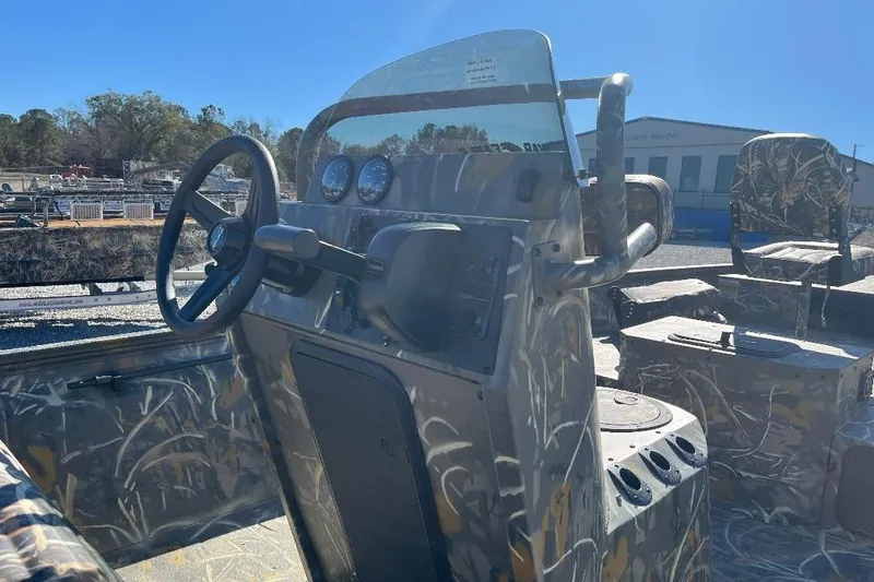 Slide: The Image of 2026 War Eagle 2170 Blackhawk boat interior with camouflage design and steering console. - 17