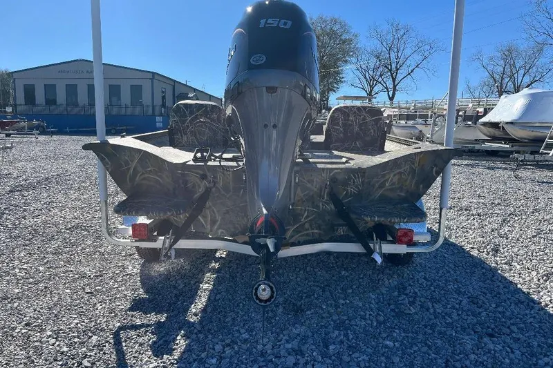 Slide: The Image of 2026 War Eagle 2170 Blackhawk boat with camo design and powerful outboard motor. - 20