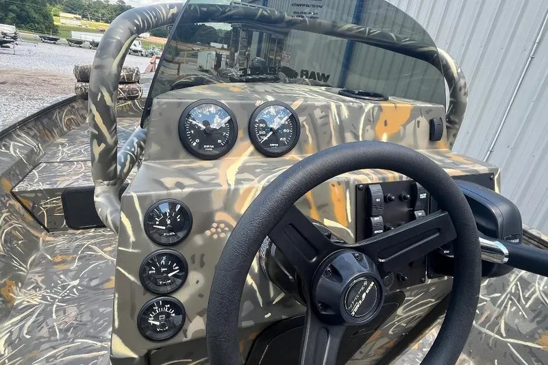 Slide: The Image of 2026 War Eagle 2170 Blackhawk boat dashboard with camo design and gauges. - 7
