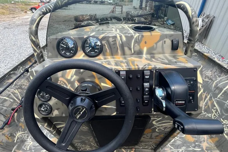 Slide: The Image of 2026 War Eagle 2170 Blackhawk boat dashboard with camo design and Yamaha controls. - 8