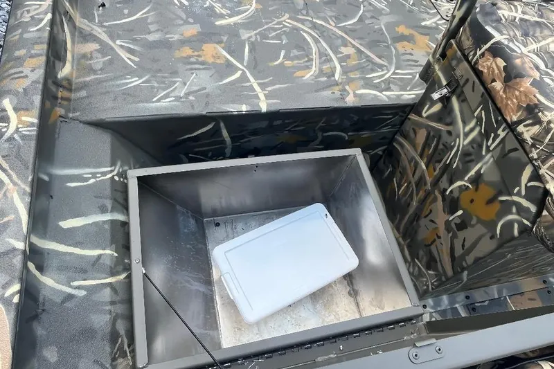 Slide: The Image of Interior of 2026 War Eagle 2170 Blackhawk boat with camouflage design and storage compartment. - 9