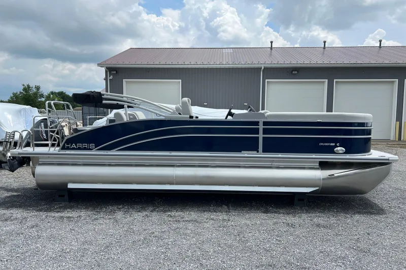 The Image of 2025 Harris Cruiser 230 pontoon boat parked outdoors, featuring sleek design and modern amenities. - 0