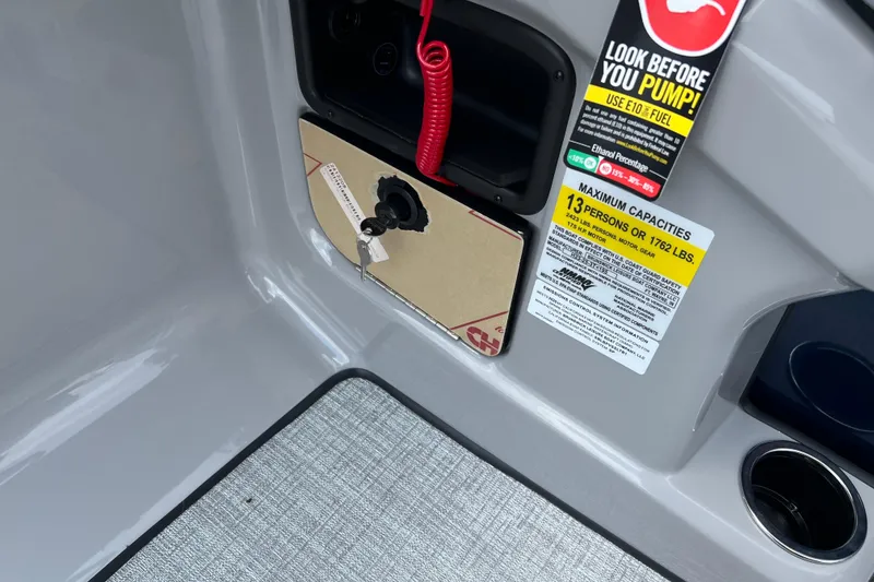 Slide: The Image of 2025 Harris Cruiser 230 boat dashboard with capacity and fuel warnings. - 11