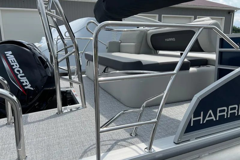 Slide: The Image of 2025 Harris Cruiser 230 pontoon boat with Mercury engine and sleek seating. - 12