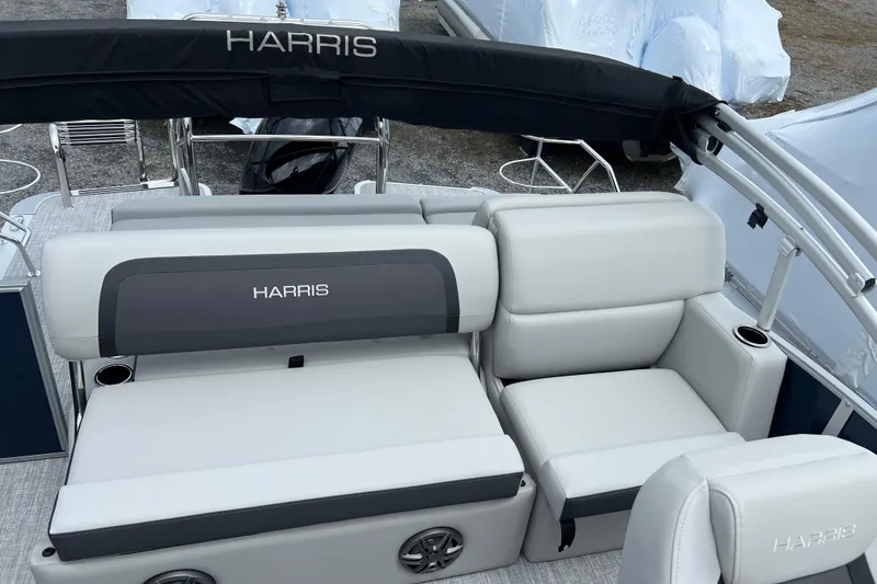 Slide: The Image of 2025 Harris Cruiser 230 boat interior with plush seating and cup holders. - 5