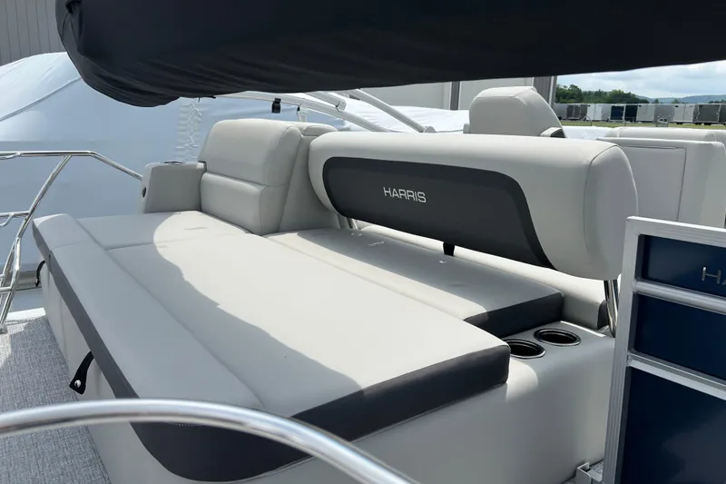 Slide: The Image of 2025 Harris Cruiser 230 boat interior with comfortable seating and cup holders. - 6