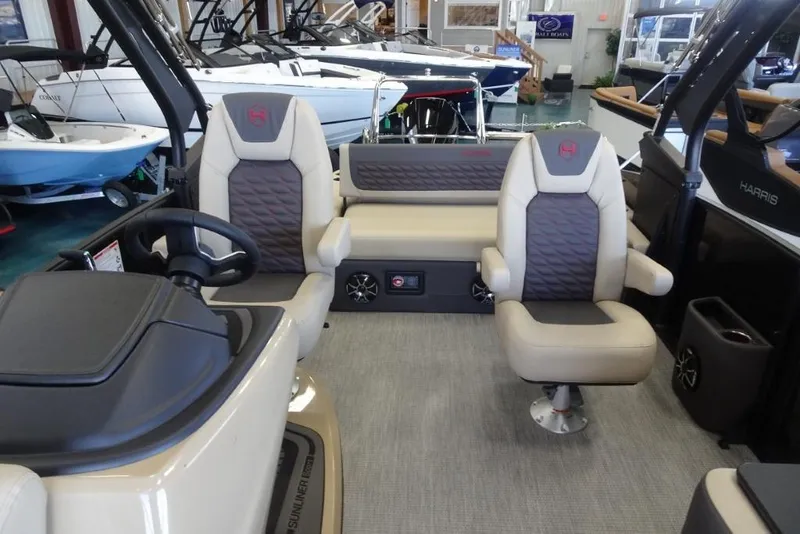 Slide: The Image of 2026 Harris Sunliner 250 Sport interior with plush seating and modern dashboard. - 12