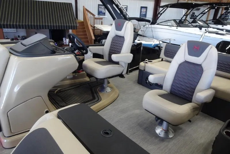 Slide: The Image of 2026 Harris Sunliner 250 Sport interior with plush seating and modern helm controls. - 13